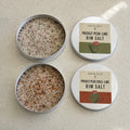 Open Prickly Pear and Prickly Pear Lime rim salt tins shown beside their labeled lids